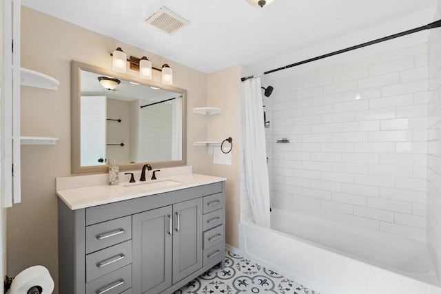 bathroom with tile patterned flooring, shower / bath combo, and vanity