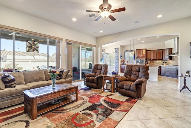 tiled living room featuring ceiling fan