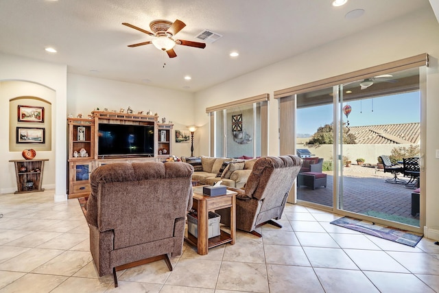 tiled living room featuring ceiling fan