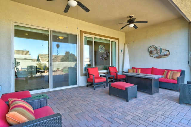 view of patio featuring an outdoor living space with a fire pit and ceiling fan