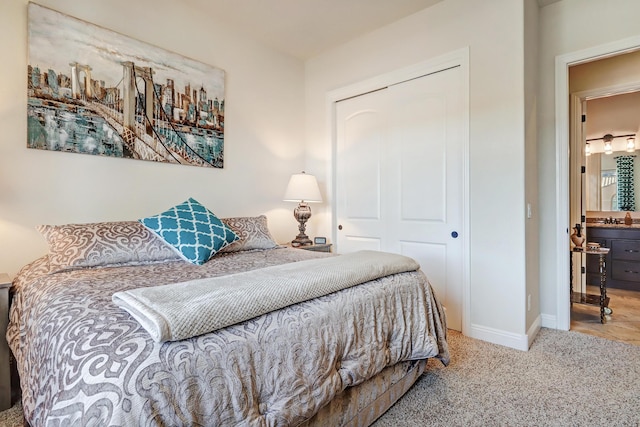 carpeted bedroom with sink and a closet