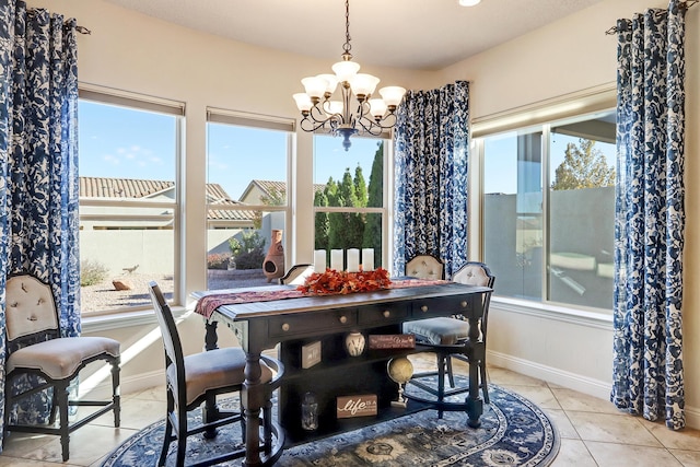 tiled dining area featuring an inviting chandelier and a healthy amount of sunlight