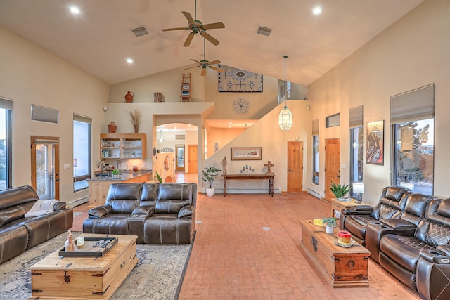 living room featuring a baseboard radiator and high vaulted ceiling