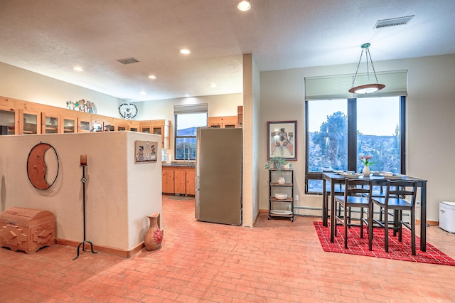 kitchen with pendant lighting and stainless steel fridge