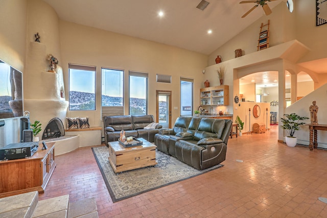 living room featuring ceiling fan and high vaulted ceiling