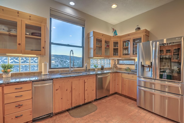 kitchen with light brown cabinetry, sink, dark stone countertops, a mountain view, and stainless steel appliances