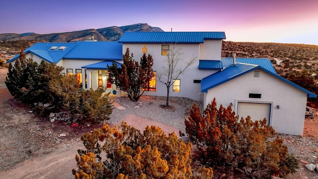 exterior space with a garage and a mountain view