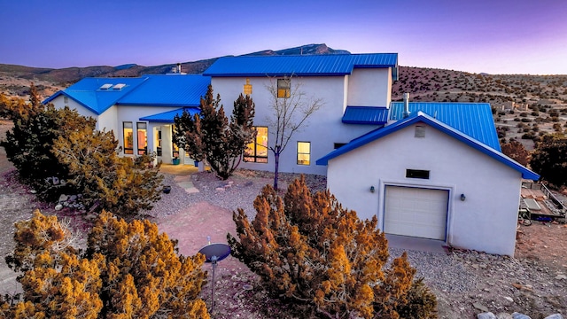 exterior space featuring a garage and a mountain view