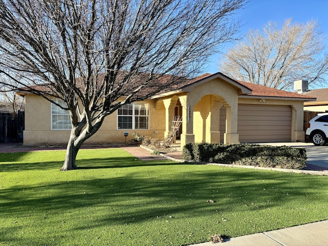 view of front of property featuring a garage and a front yard