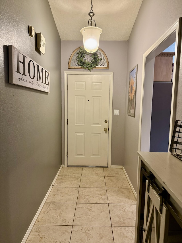 entryway featuring a textured ceiling and light tile patterned flooring