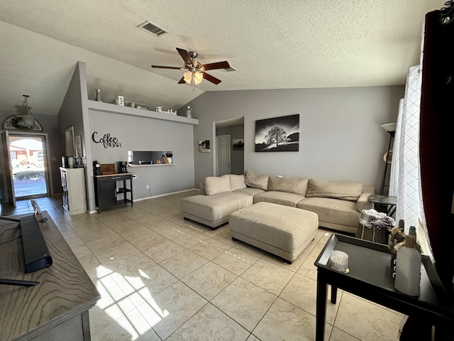 tiled living room with ceiling fan, lofted ceiling, and a textured ceiling