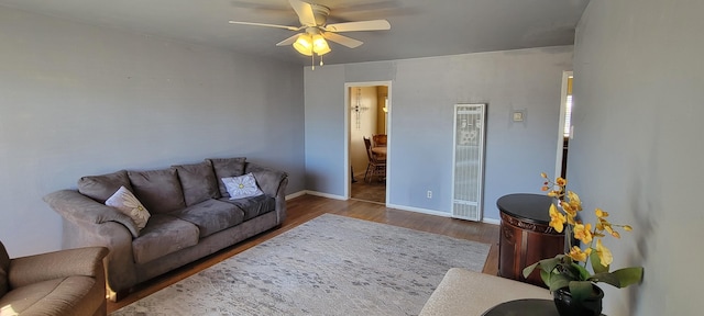 living room with hardwood / wood-style flooring and ceiling fan