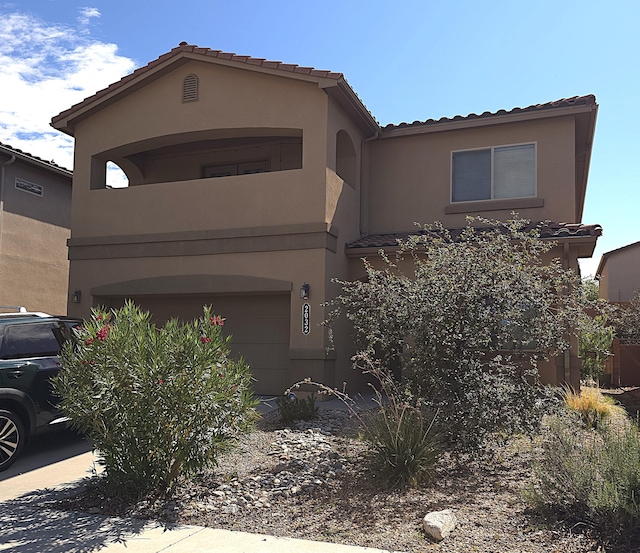 mediterranean / spanish-style home with a garage