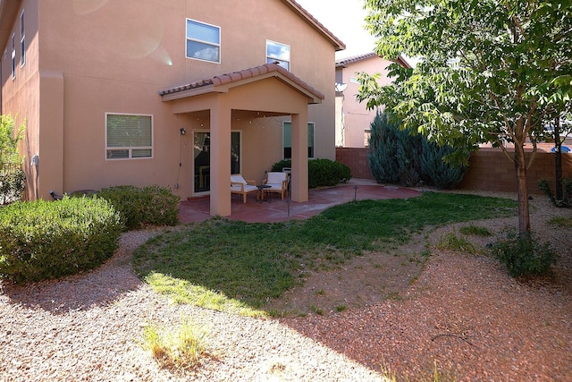 back of house with a patio