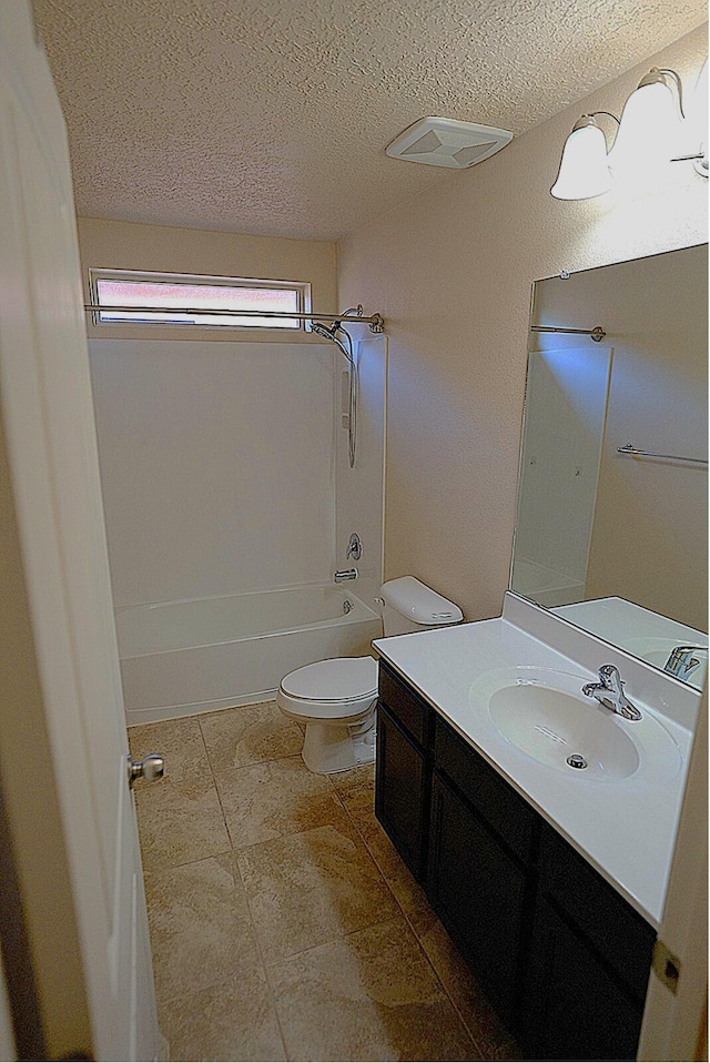 full bathroom with tile patterned floors, toilet, a textured ceiling, shower / bathtub combination, and vanity