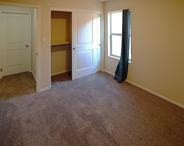 unfurnished bedroom with carpet floors and a closet