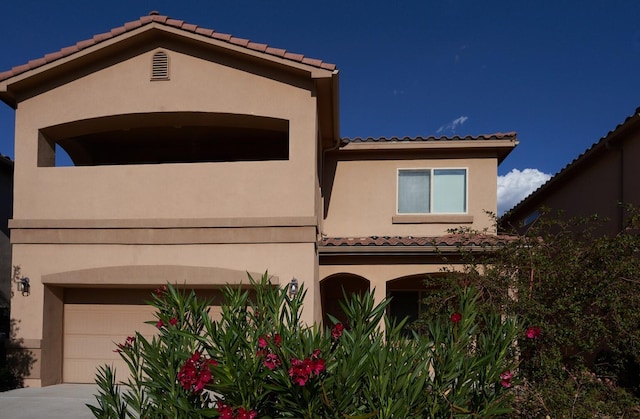 mediterranean / spanish-style home featuring a garage