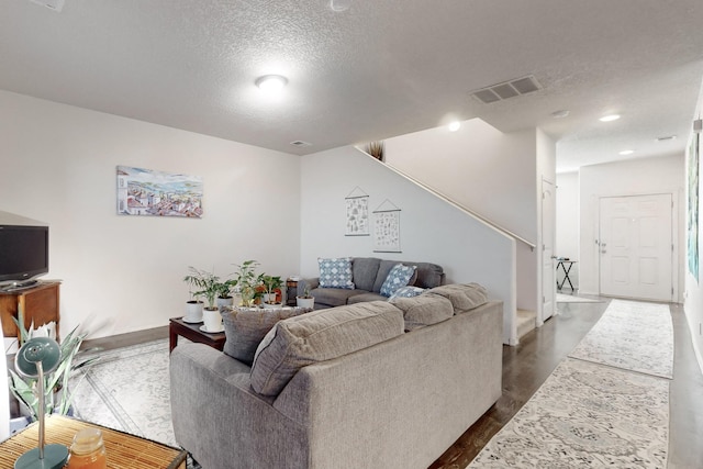 living room with a textured ceiling