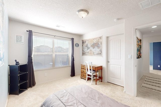 carpeted bedroom with a textured ceiling