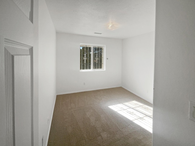 spare room featuring carpet floors