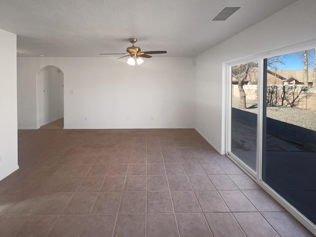 tiled empty room with ceiling fan