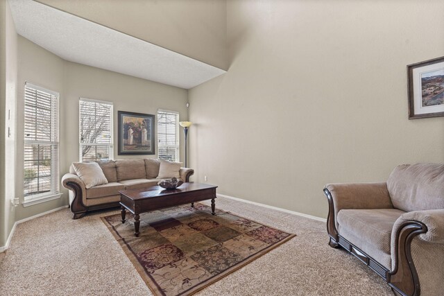 4823 Mcnary Ct NW, Albuquerque, NM 87120 - carpeted living room with arched walkways, a towering ceiling, stairway, and baseboards