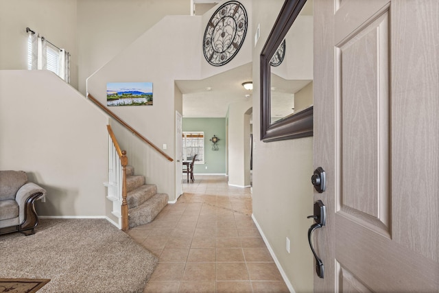 entrance foyer featuring a high ceiling and light tile patterned floors