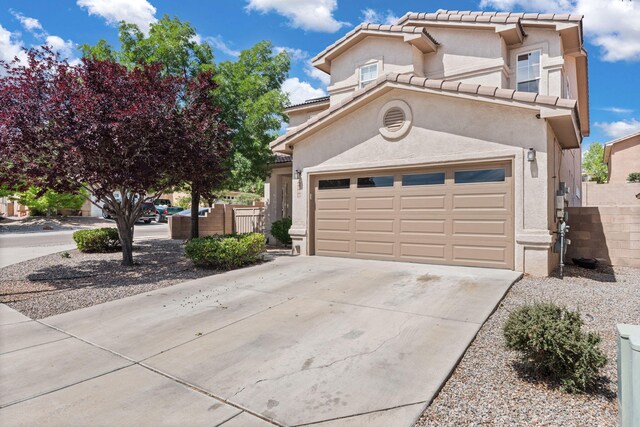4823 Mcnary Ct NW, Albuquerque, NM 87120 - view of front of house featuring driveway, stucco siding, a tiled roof, and a garage