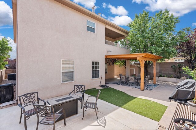 4823 Mcnary Ct NW, Albuquerque, NM 87120 - fenced backyard featuring an outdoor fire pit, a patio, and a balcony