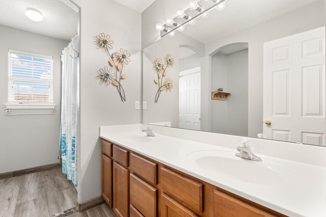 bathroom with vanity, hardwood / wood-style floors, and a textured ceiling