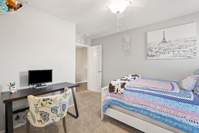 carpeted bedroom with a textured ceiling and ceiling fan