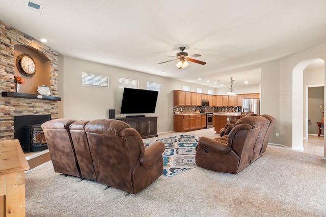 carpeted living room featuring ceiling fan