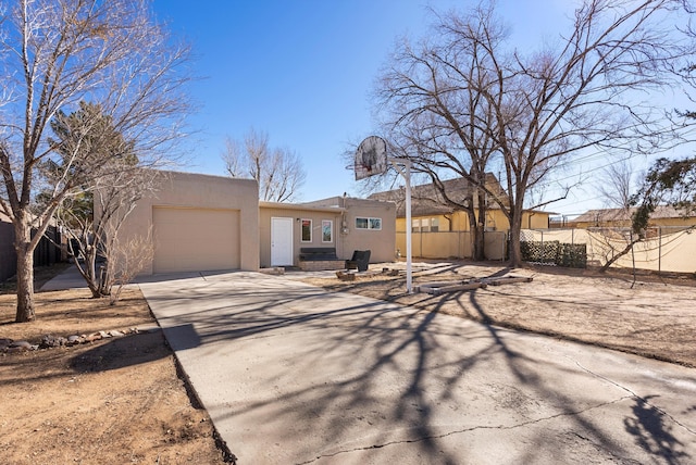 pueblo-style house featuring a garage