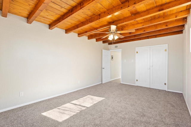 unfurnished bedroom featuring wood ceiling, beam ceiling, ceiling fan, and carpet flooring