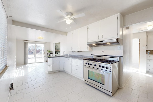 kitchen with high end stainless steel range, white cabinetry, a textured ceiling, kitchen peninsula, and ceiling fan