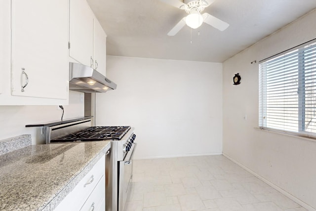 kitchen with white cabinetry, ceiling fan, and stainless steel stove