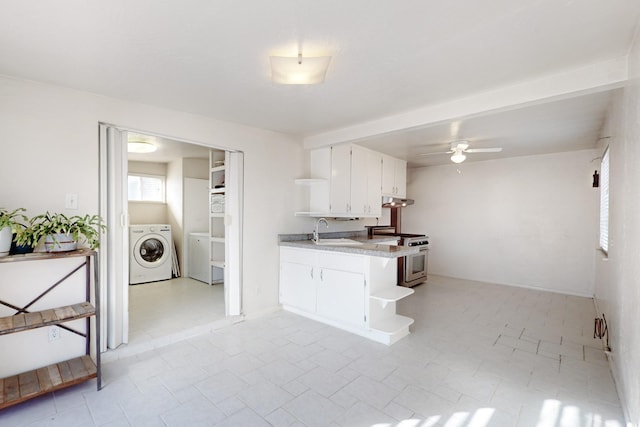 kitchen with sink, white cabinetry, kitchen peninsula, high end stainless steel range oven, and washer / clothes dryer