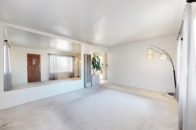 unfurnished living room featuring light colored carpet