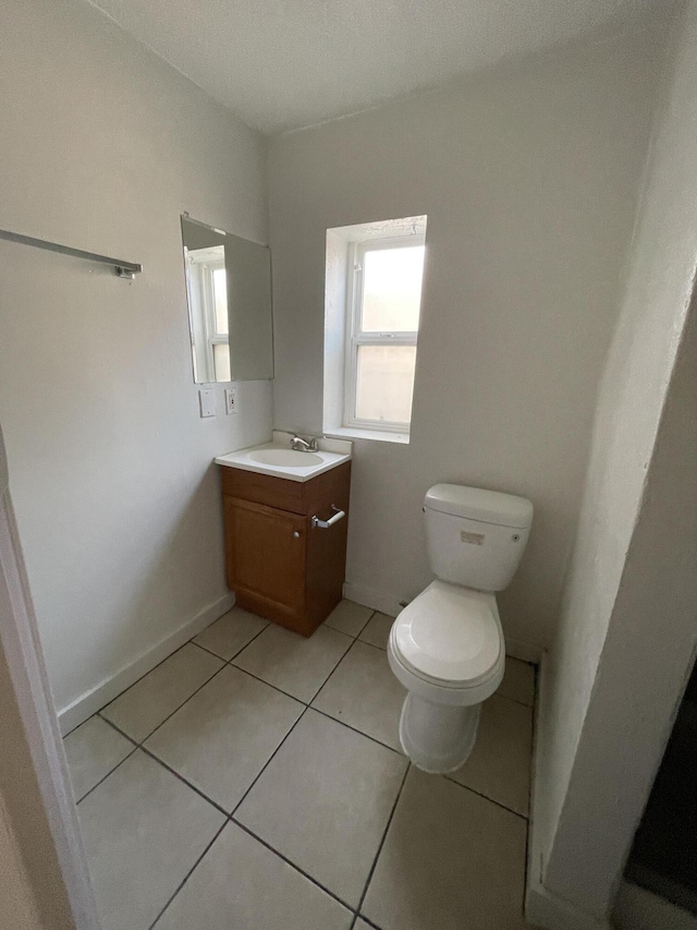 bathroom featuring tile patterned flooring, vanity, and toilet