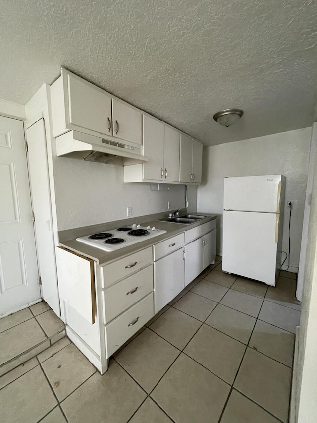 kitchen featuring white cabinetry, light tile patterned floors, and white appliances