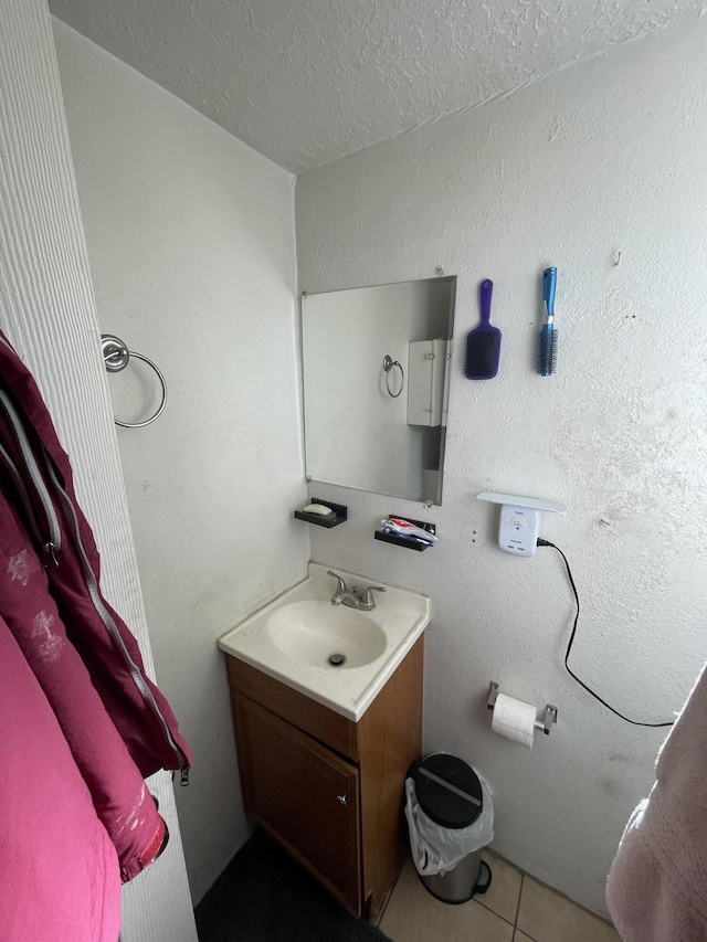 bathroom featuring tile patterned floors, vanity, and a textured ceiling