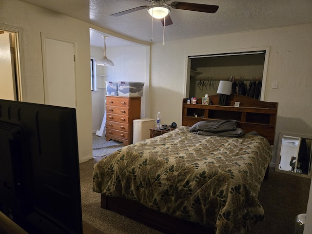 bedroom with ceiling fan, carpet floors, a closet, and a textured ceiling