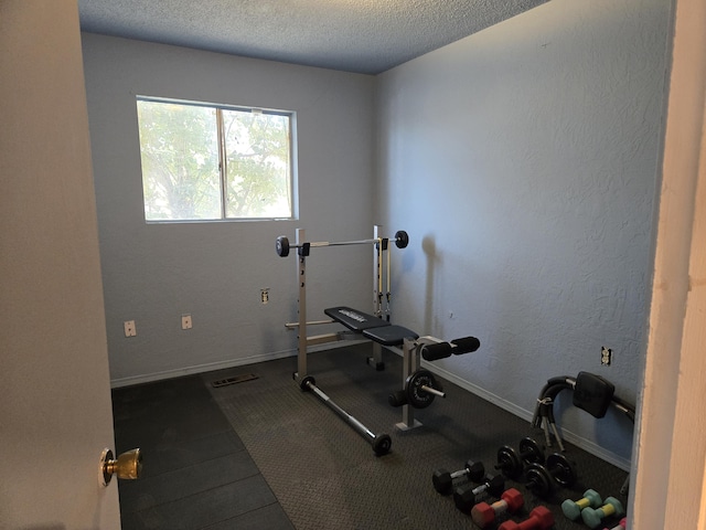 exercise area featuring a textured ceiling