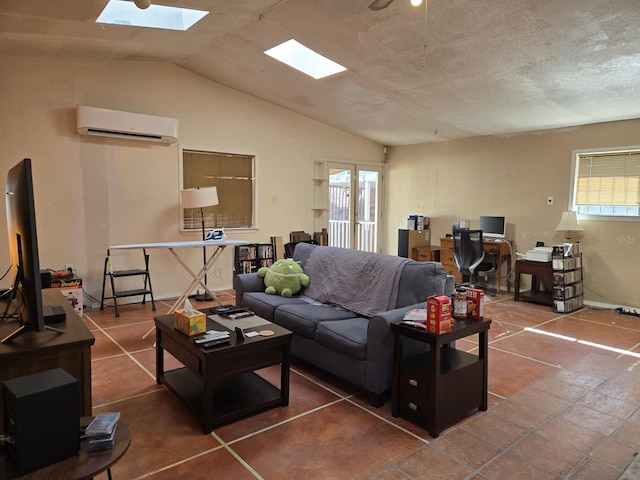 living room featuring tile patterned flooring, lofted ceiling with skylight, a wealth of natural light, and a wall unit AC