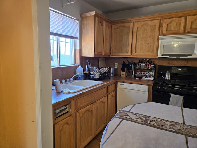 kitchen featuring sink, tile countertops, and white appliances