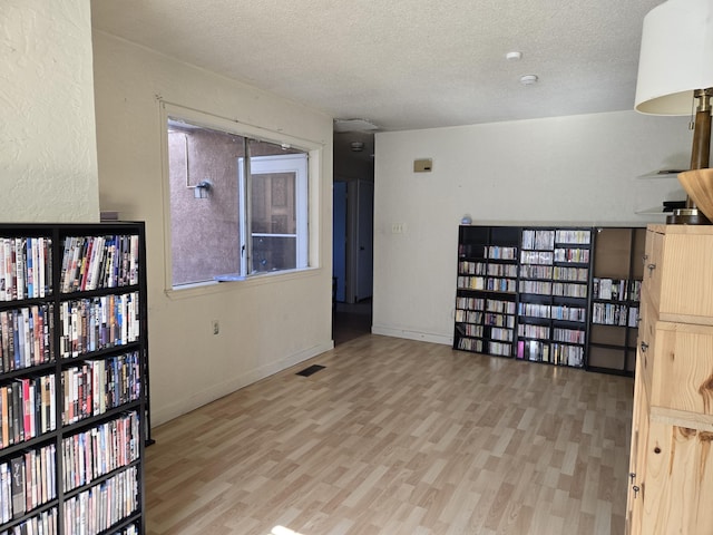 interior space featuring hardwood / wood-style floors and a textured ceiling