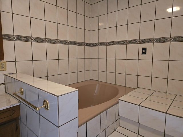 bathroom featuring tile walls and tiled bath