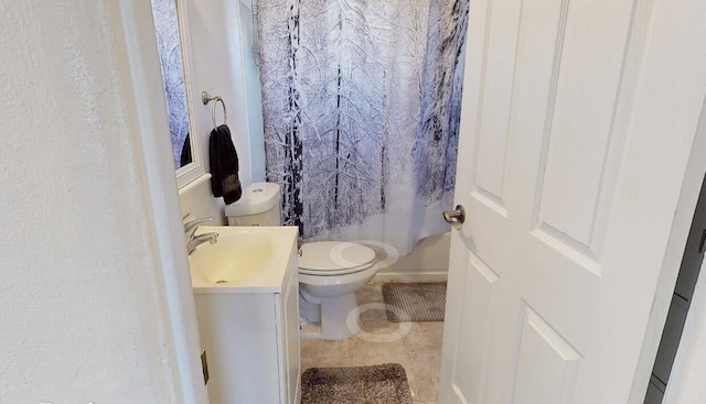 bathroom with vanity, toilet, and tile patterned floors