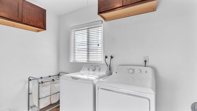 washroom featuring separate washer and dryer and cabinets