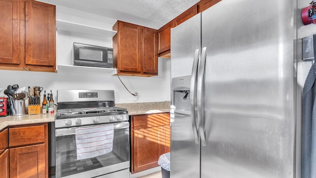 kitchen with stainless steel appliances and light stone countertops